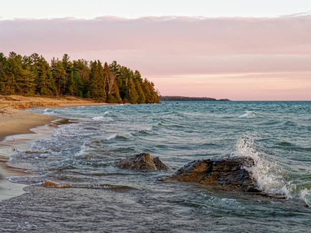 Waves crashing on rocks during a stunning sunset