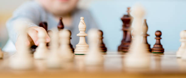 istock The child plays chess 1202495722