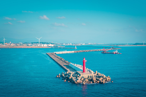 Navigation Ocean light house in  Takamatsu Bay, Japan. while the sun is setting. For Navigation and guiding concept.