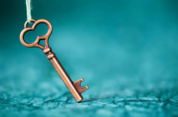 Escape room concept, key on blue background with copy space