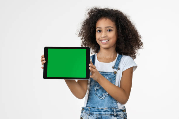istock Happy child with tablet isolated on white background 1202500340