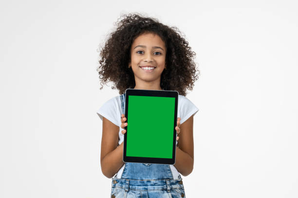 little girl with the digital tablet on white background - child computer laptop little girls imagens e fotografias de stock