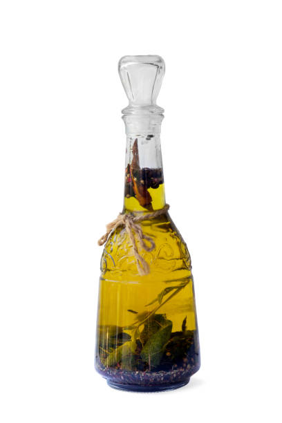 istock a bottle with vegetable oil and aromatic herbs  isolated on white background 1202500614