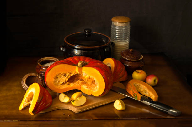istock Red French pumpkin, slices, brown pottery, apples. 1202504232