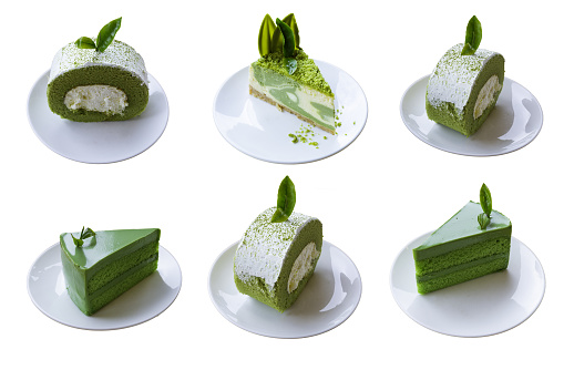 Closeup pieces of green tea cake and roll  with tea leaf topping isolated on white background.