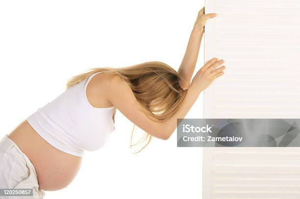 Tired Pregnant Woman Leaned On The Door Stock Photo - Download Image Now - 30-39 Years, Abdomen, Adult