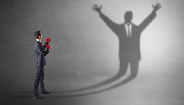 istock Businessman fighting with a disarmed businessman shadow 1202509043