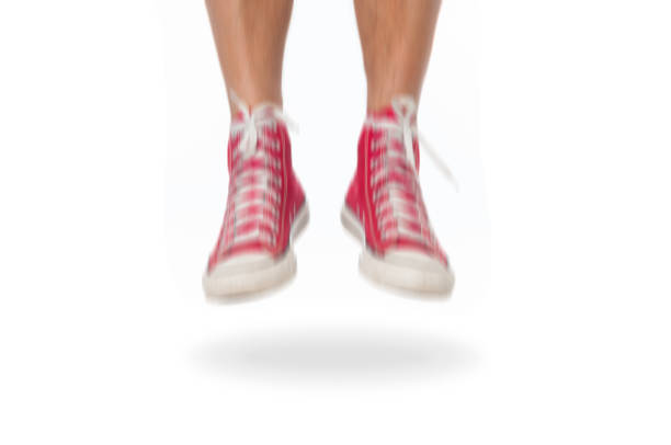 istock Man jumping in red sneakers on white background. Image in motion blur 1202509499