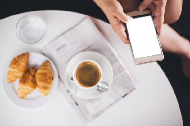 Reading morning news during breakfast Woman hand using blank smart phone, reading morning news during breakfast 3686 stock pictures, royalty-free photos & images