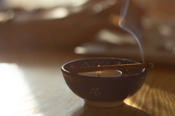 istock candle and incense near workplace and laptop 1202510887