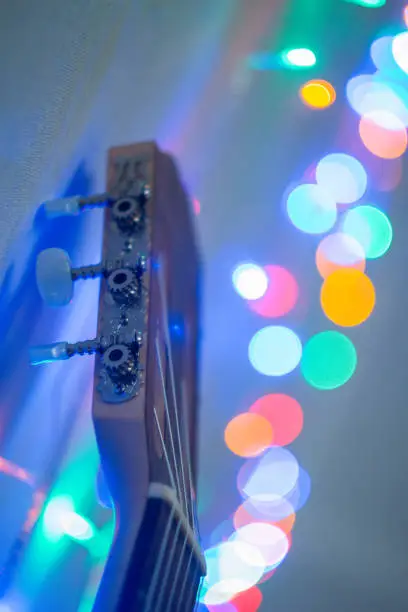 Upper part of guitar at blurred blue interior