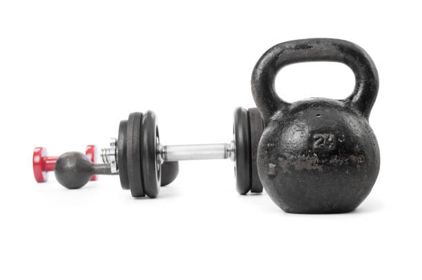 istock Kettlebell close up and dumbbells on white background 1202511372