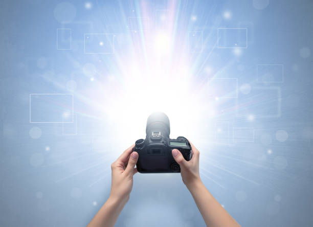 istock Hand taking photo with glowing flash concept 1202511473