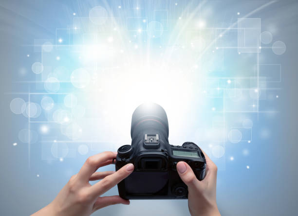 istock Hand taking photo with glowing flash concept 1202511532