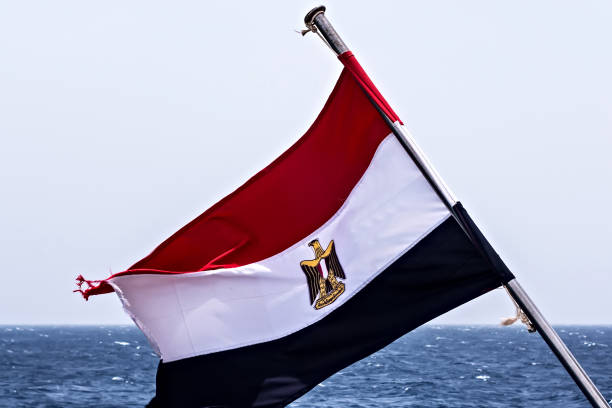 Egyptian flag against the Nile river. Egypt, North Africa.