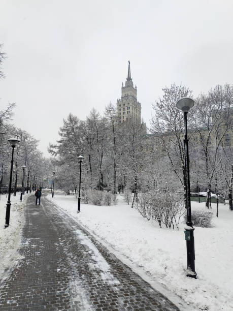 istock A path in a winter square against the background of a Soviet-era high-rise building. 1202517650