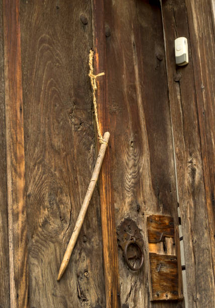 istock an old wooden door with a primitive key and a modern bell 1202519493