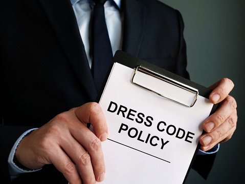 Manager is holding Dress code policy.