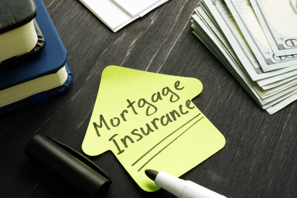 istock Mortgage Insurance memo with money and calculator. 1202519907