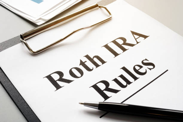 istock Roth IRA rules with stack of papers and pen. 1202520120