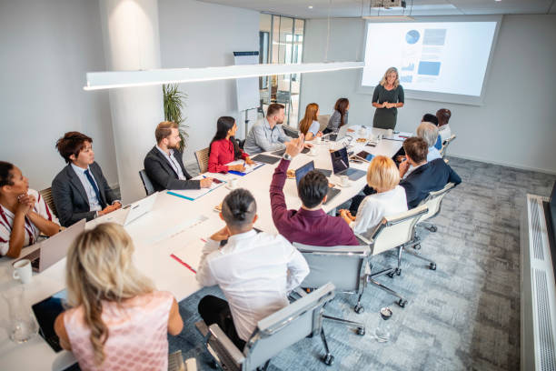 istock Female Business Executive Making Presentation in Board Room 1202520793