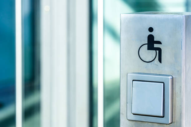 istock disabled sign and door opening button 1202521473