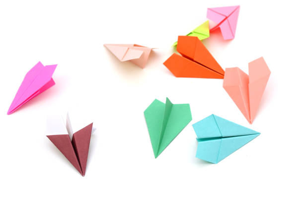 istock Assorted of colored paper planes on white 1202523806