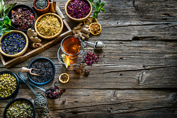 istock Herbal tea: various dried tea leaves and flowers shot from above on rustic wooden table. Copy space 1202524014