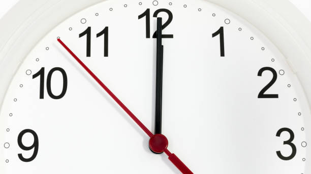 istock Closeup clock ticking showing twelve hours 1202525131
