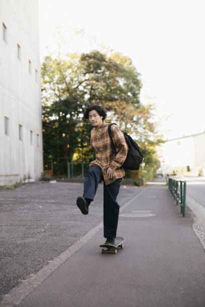 istock Young Man Skateboarding on the Street 1202525924