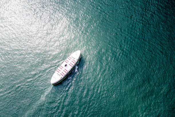 Seascape, blue water surface and nautical vessel. Full frame image suitable for background purposes. Copy space available on the upper side of the image. Madeira island, Portugal.