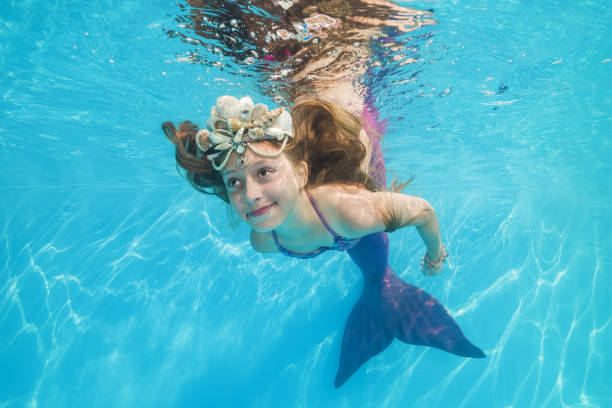 girl in a mermaid costume poses underwater in a pool. Young beautiful girl poses underwater in the pool. girl in a mermaid costume poses underwater in a pool. Young beautiful girl poses underwater in the pool. life stile stock pictures, royalty-free photos & images