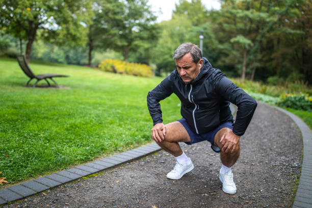 istock Senior man stretching before jogging alone in public park on autumn morning 1202530664