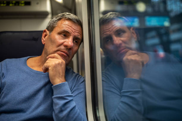 istock Exhausted mature tourist in train 1202530975