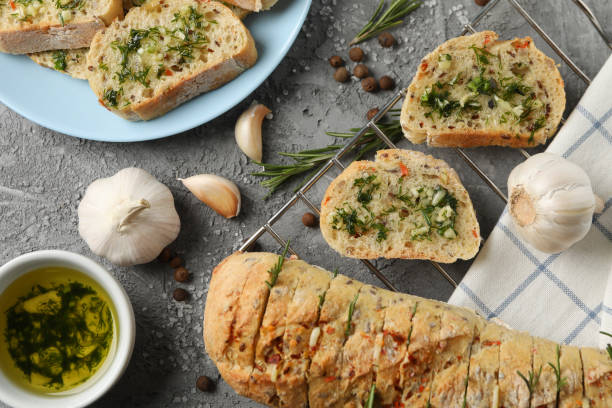 istock Tasty garlic bread and spices on grey background, top view 1202530991