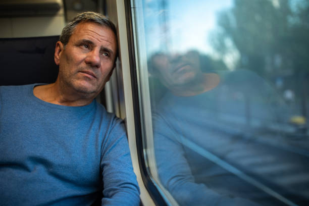 istock Exhausted mature tourist in train 1202531000
