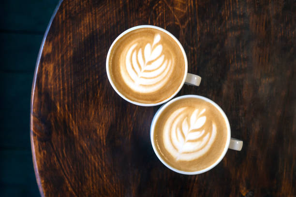 istock Two cups of cappuccino with latte art. 1202532184