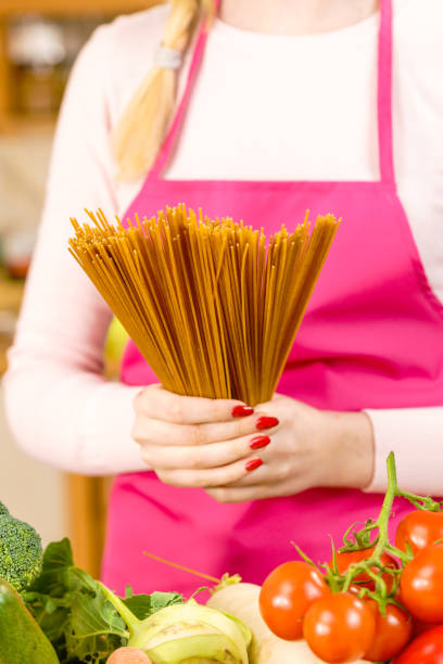 istock Woman holding long pasta 1202532267