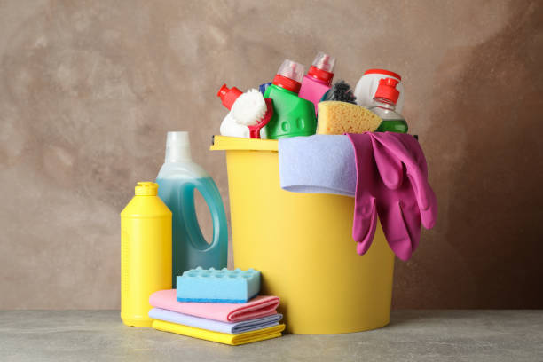 istock Bottles with detergent and cleaning supplies on brown background, space for text 1202533900