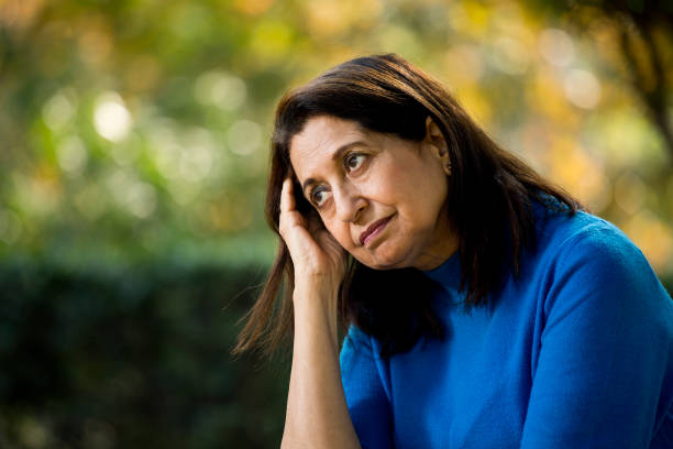 istock Thoughtful old woman at park 1202534157