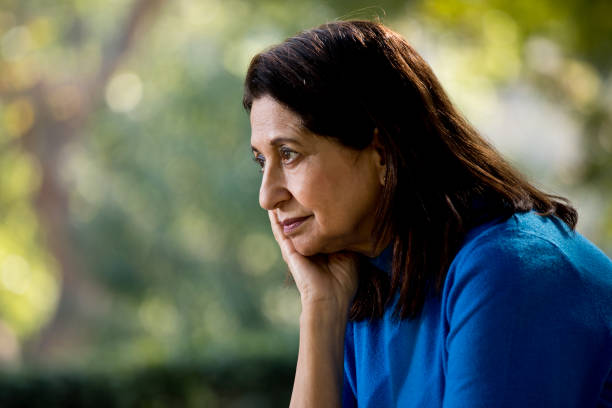 istock Thoughtful old woman at park 1202534804