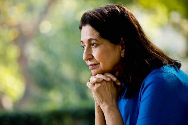 istock Thoughtful old woman at park 1202534853