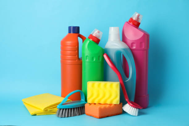 istock Bottles with detergent and cleaning supplies on blue background, space for text 1202534896