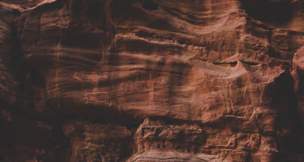 istock ancient cave paintings in Middle East desert sand stone rocks wall soft focus background archaeological object 1202535164
