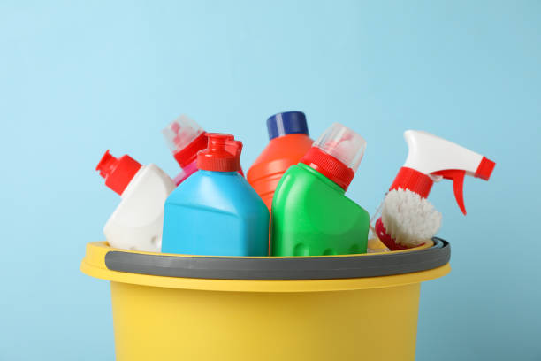 istock Bucket with detergent and cleaning supplies on blue background, space for text 1202535200
