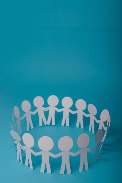 istock abstract paper people holding for hands 1202535456