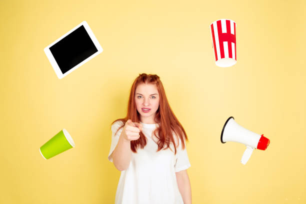 istock Caucasian young woman's portrait on yellow background, too much tasks 1202536526