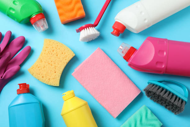 istock Detergents and cleaning supplies on blue background, top view 1202536603