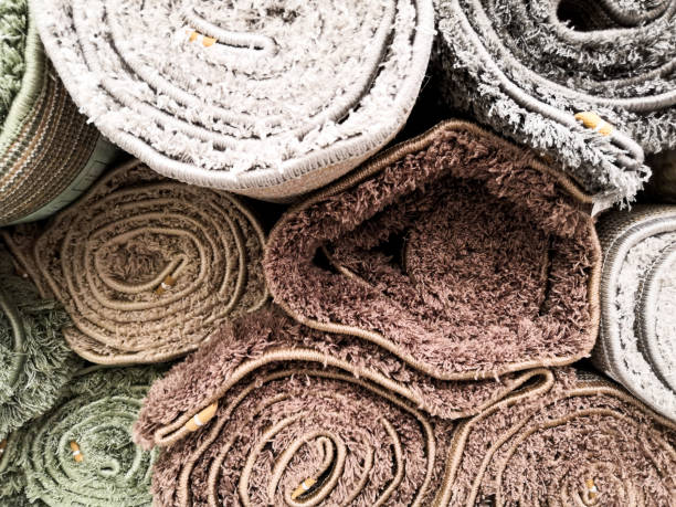 istock Carpets variety selection rolled up rugs shop store 1202538094