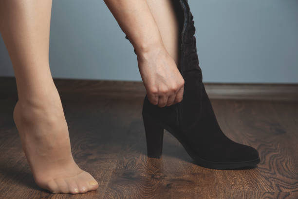 istock woman foot with shoes 1202538336